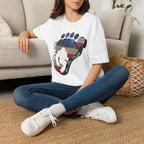 Going Norther Bigfoot T-Shirt — Footprint Silhouette with Distressed Flag & "1776 - 2026 - We The People"