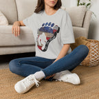 Going Norther Bigfoot T-Shirt — Footprint Silhouette with Distressed Flag & "1776 - 2026 - We The People"