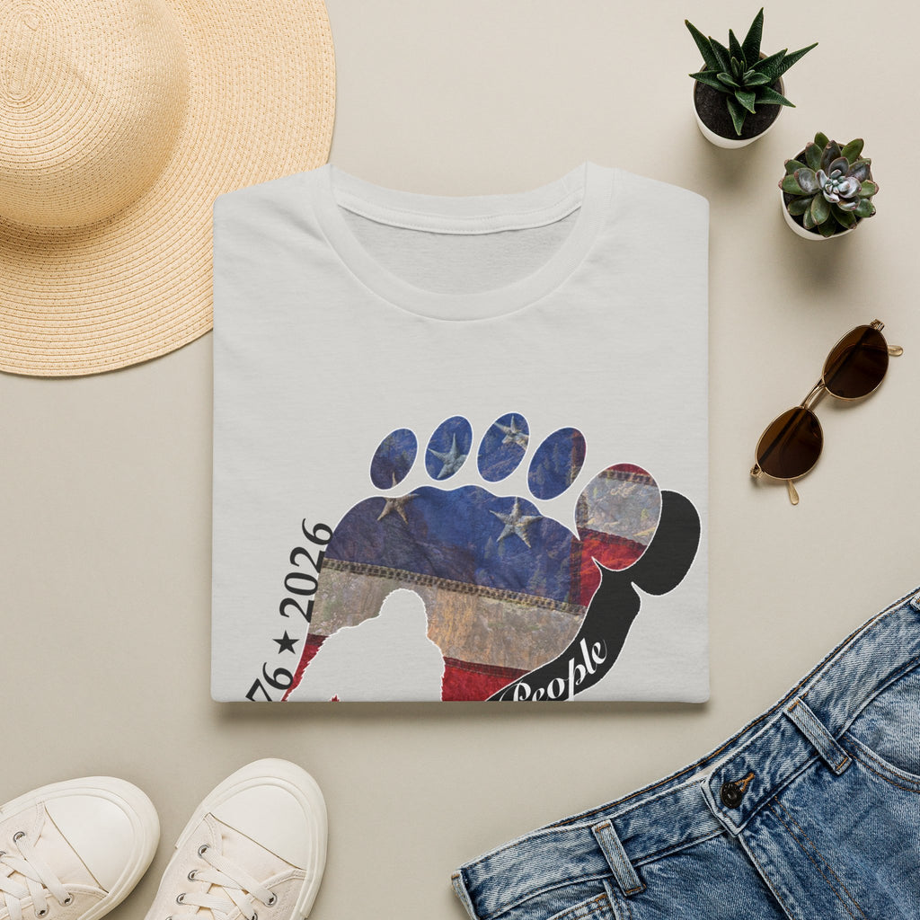 Going Norther Bigfoot T-Shirt — Footprint Silhouette with Distressed Flag & "1776 - 2026 - We The People"