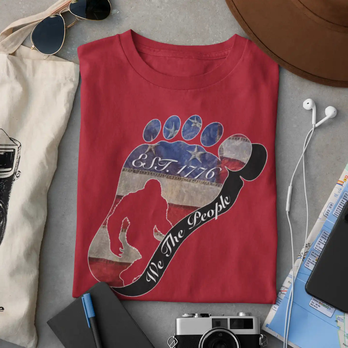 Going Norther Bigfoot T-Shirt — Footprint Silhouette with Distressed Flag "EST. 1776 - We The People"