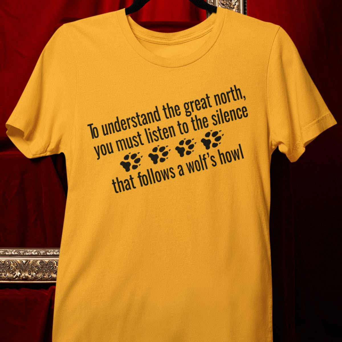 T-Shirt — "To understand the great north, you must listen to the silence that follows a wolf's howl" Paw Print Design